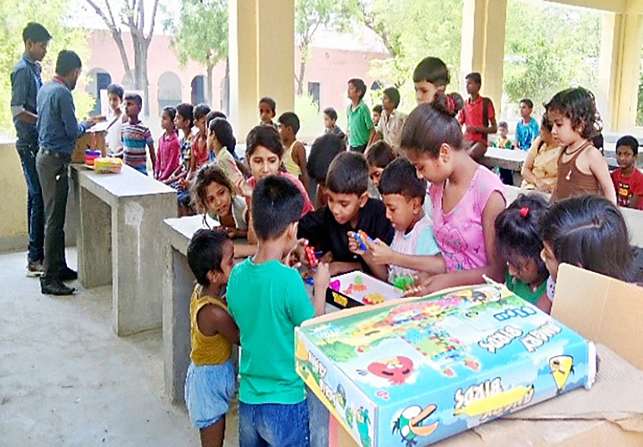 “Children playing games during Mobile Library’s visit in Rai Village ” by Dr Rangashri Kishore is licensed under CC BY 4.0