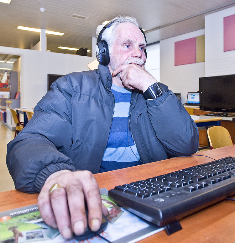 “Man using computer in local library ” by Gert Jan van Heyningen is licensed under CC BY 4.0